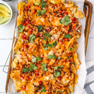 fully cooked bbq chicken nachos on a sheet pan