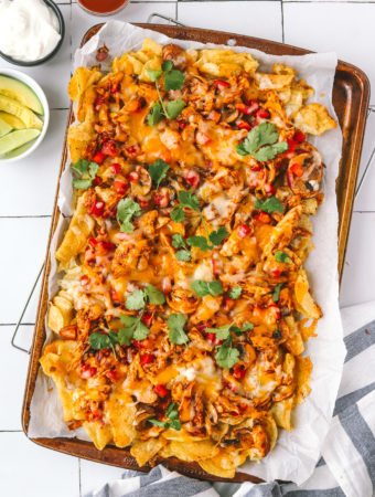 fully cooked bbq chicken nachos on a sheet pan