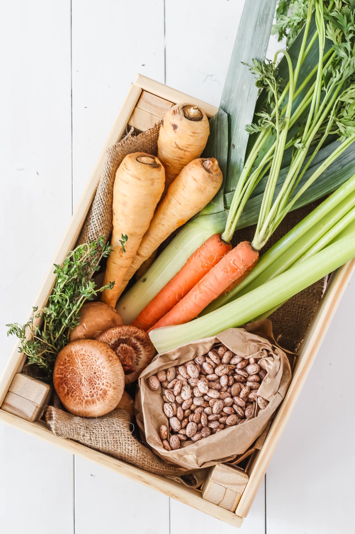 parsnips, carrots, leeks, beans, mushrooms and fresh thyme in a carton