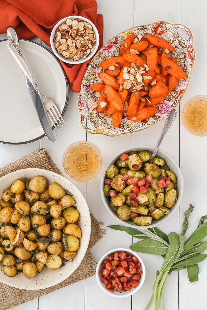 table with bowls of Carrots, Brussels Sprouts and Potatoes