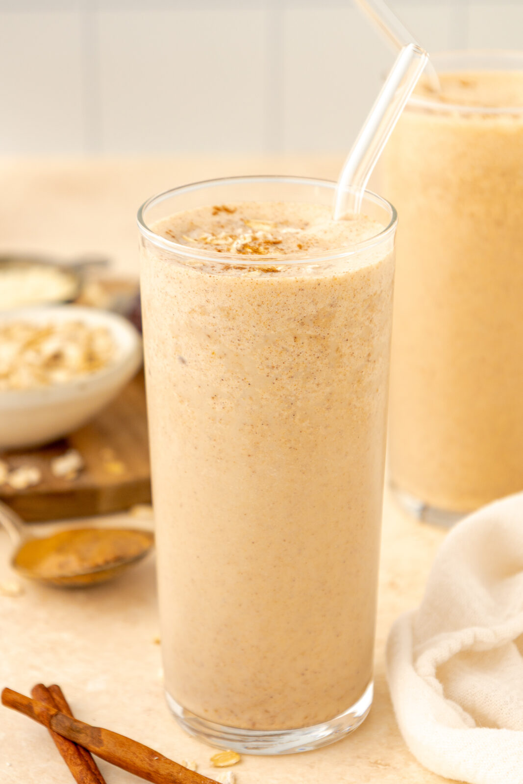 oatmeal cookie smoothie in clear glass with a straw