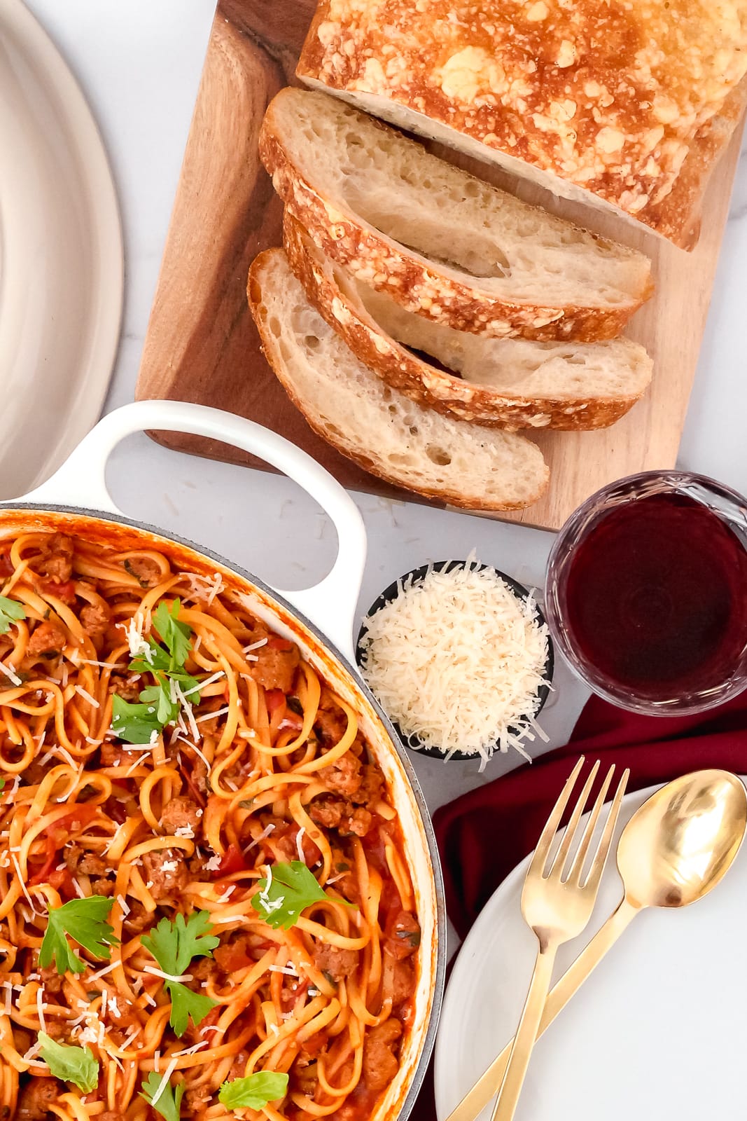 bread, wine and shredded parmesan cheese - sides for a one pot pasta