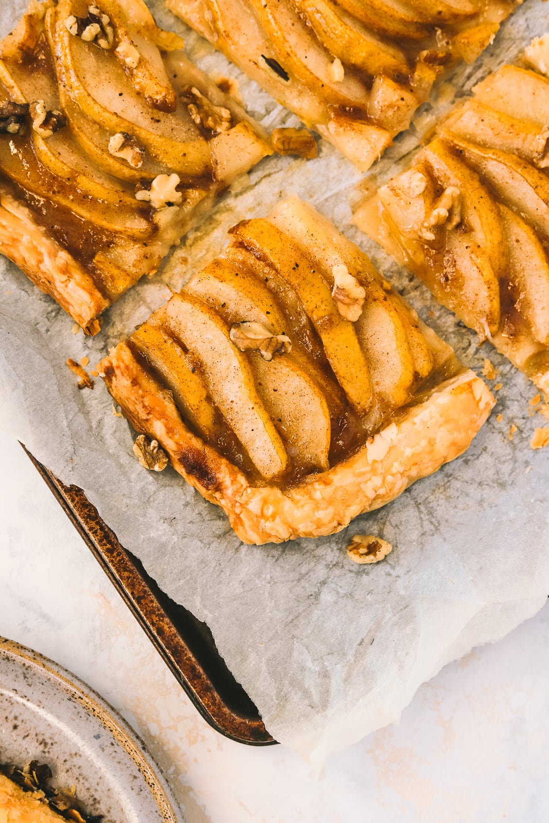 piece of pear tart cut on a baking sheet