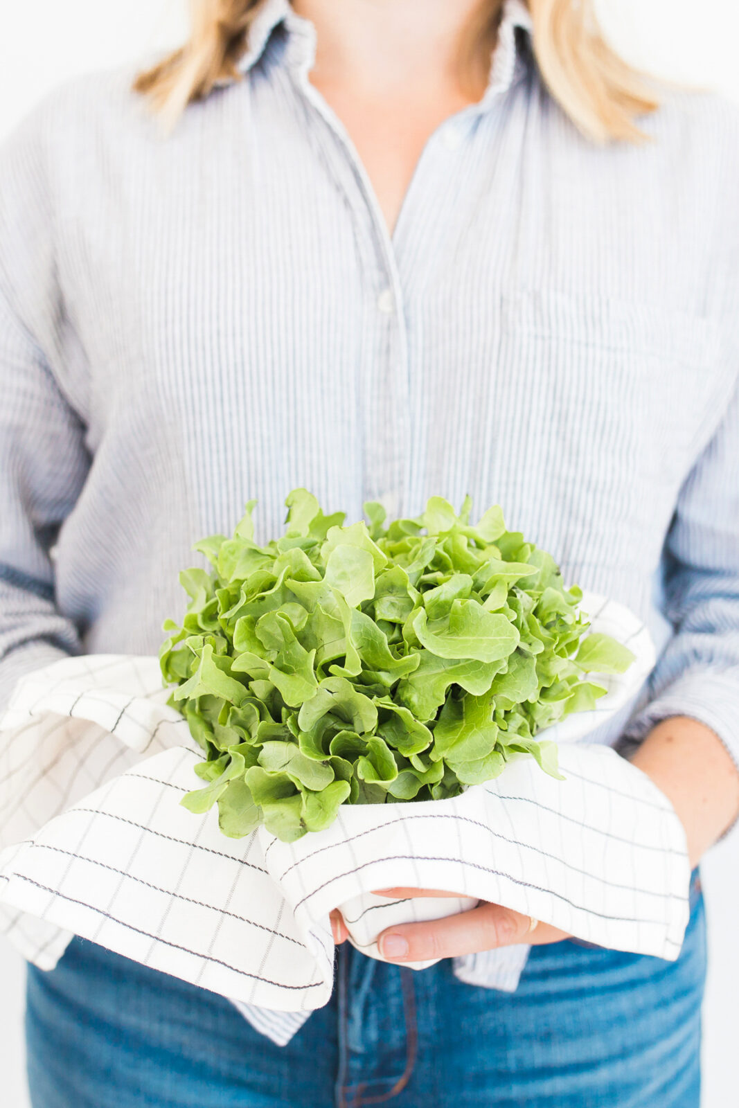 person holding leaf lettuce like a bouquet