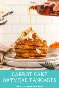 a hand pouring syrup from a jar onto carrot cake pancakes