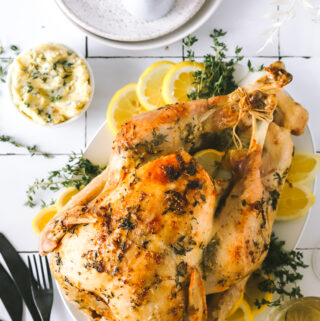 roasted turkey with lemon and herbs on a platter