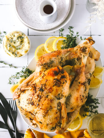 roasted turkey with lemon and herbs on a platter