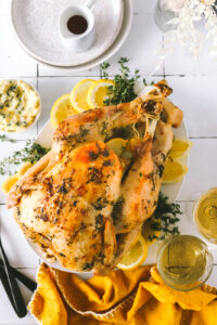 roasted turkey with lemon and herbs on a platter