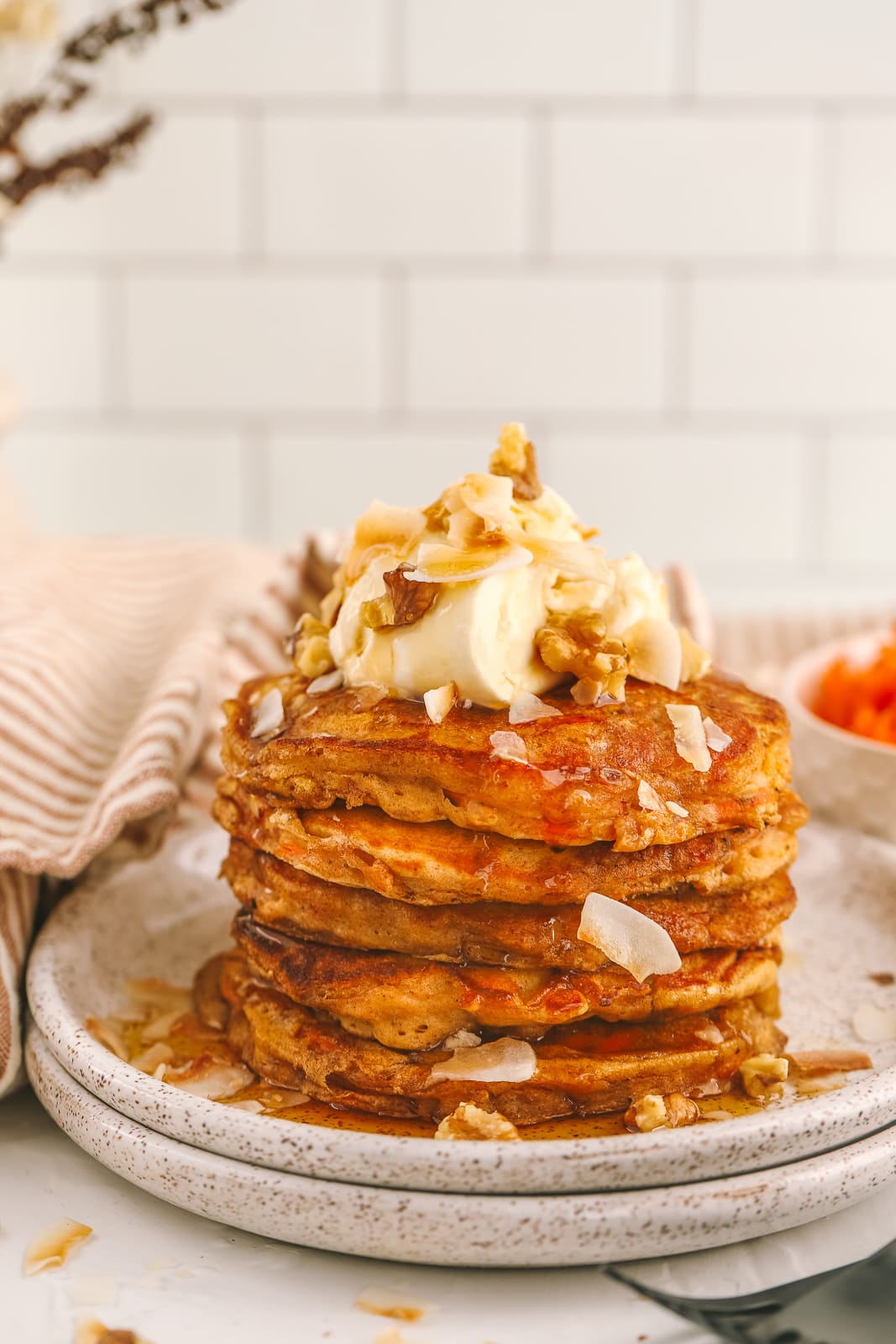 a stack of carrot cake oatmeal pancakes