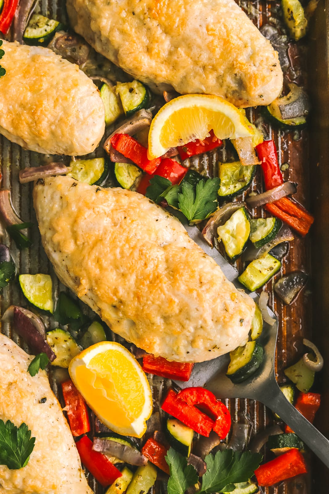 roasted chicken with vegetables on a sheet pan