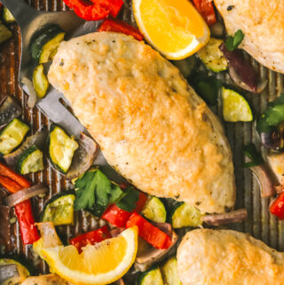 roasted chicken with vegetables on a sheet pan