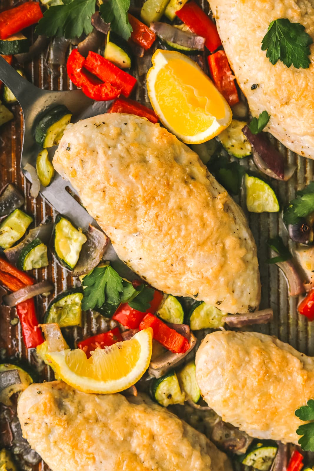 roasted chicken with vegetables on a sheet pan
