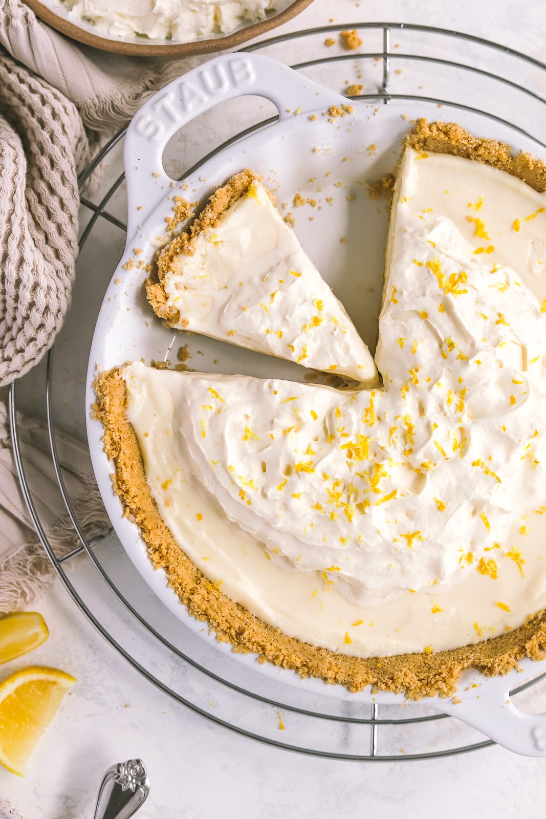 sliced of lemon pie topped with whipped cream