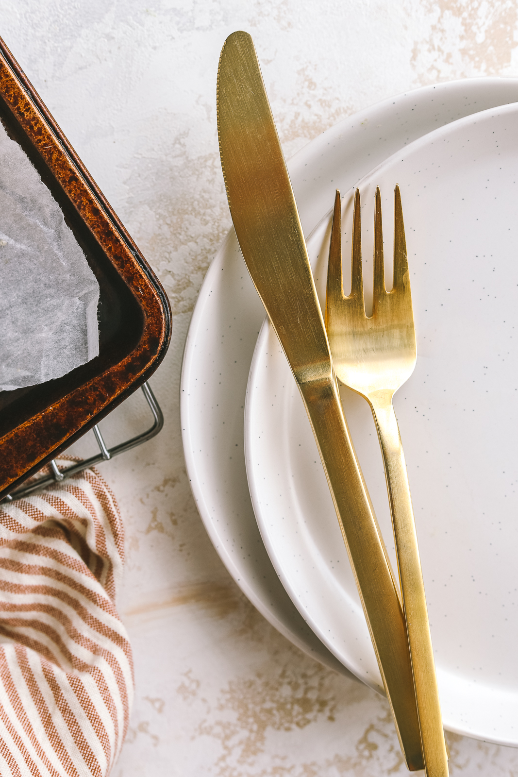 gold utensils on a plate