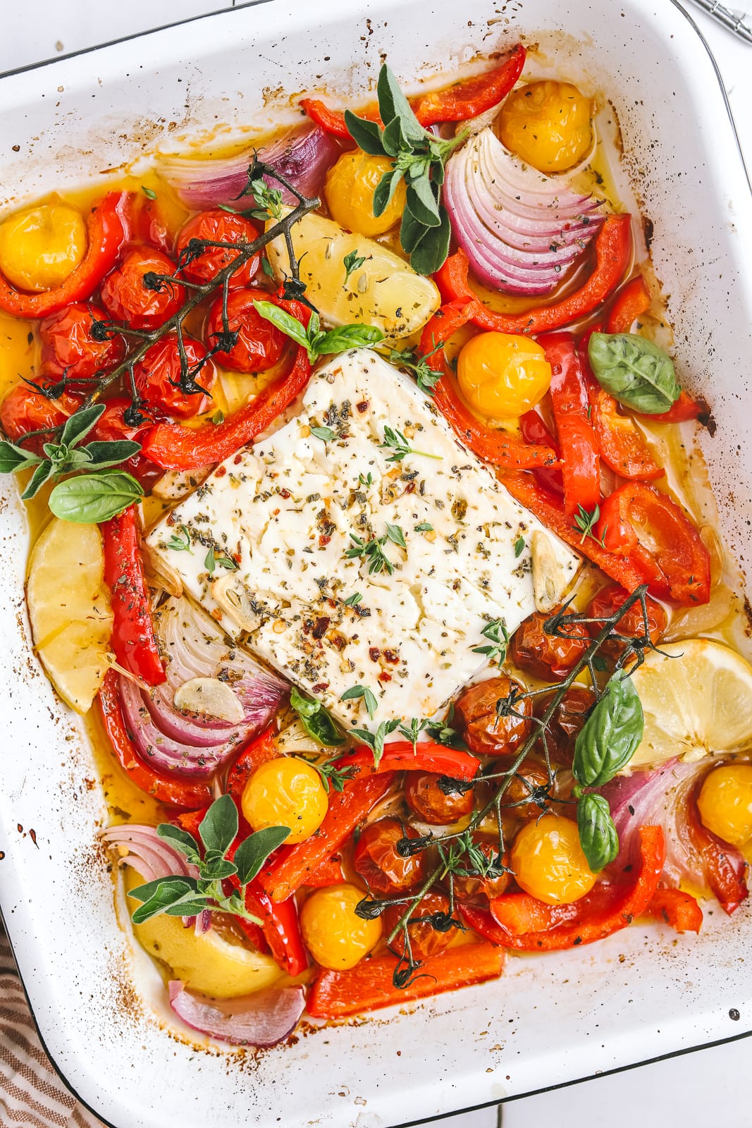 baked feta in a pan with summer vegetables