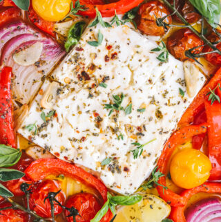 baked feta in a pan with summer vegetables