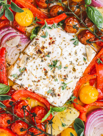 baked feta in a pan with summer vegetables