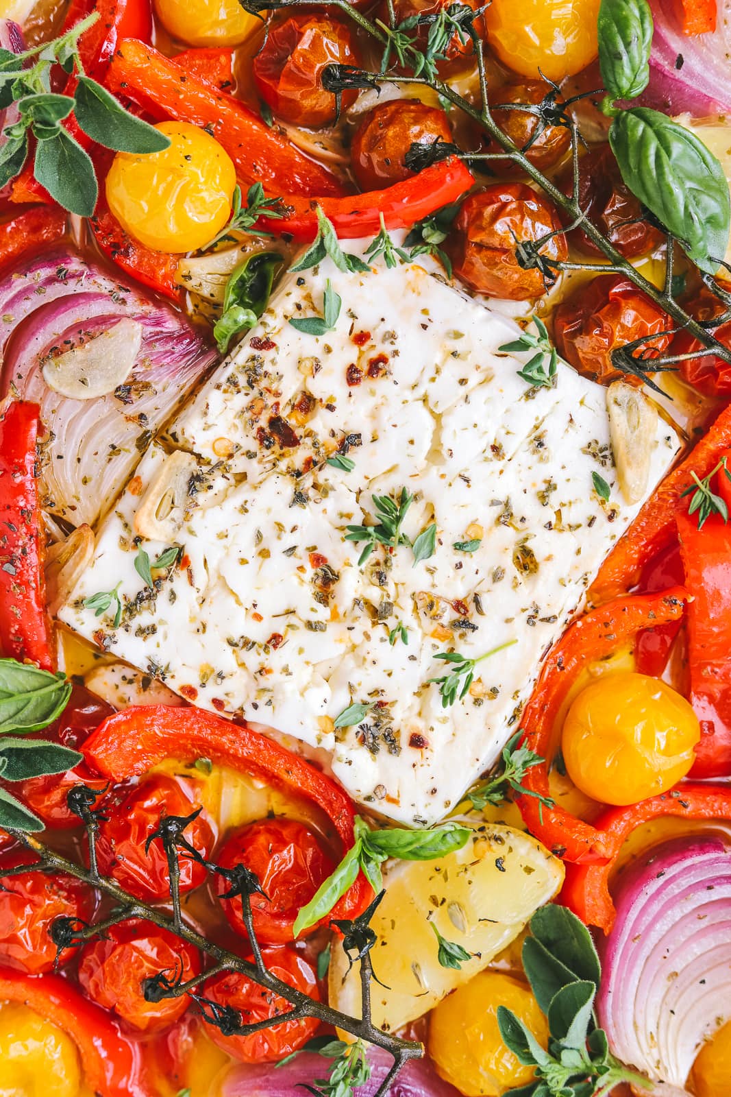 baked feta in a pan with summer vegetables