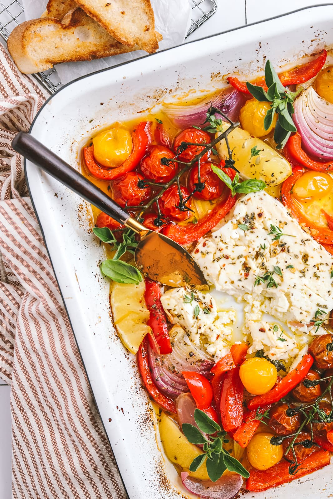 baked feta with a serving knife