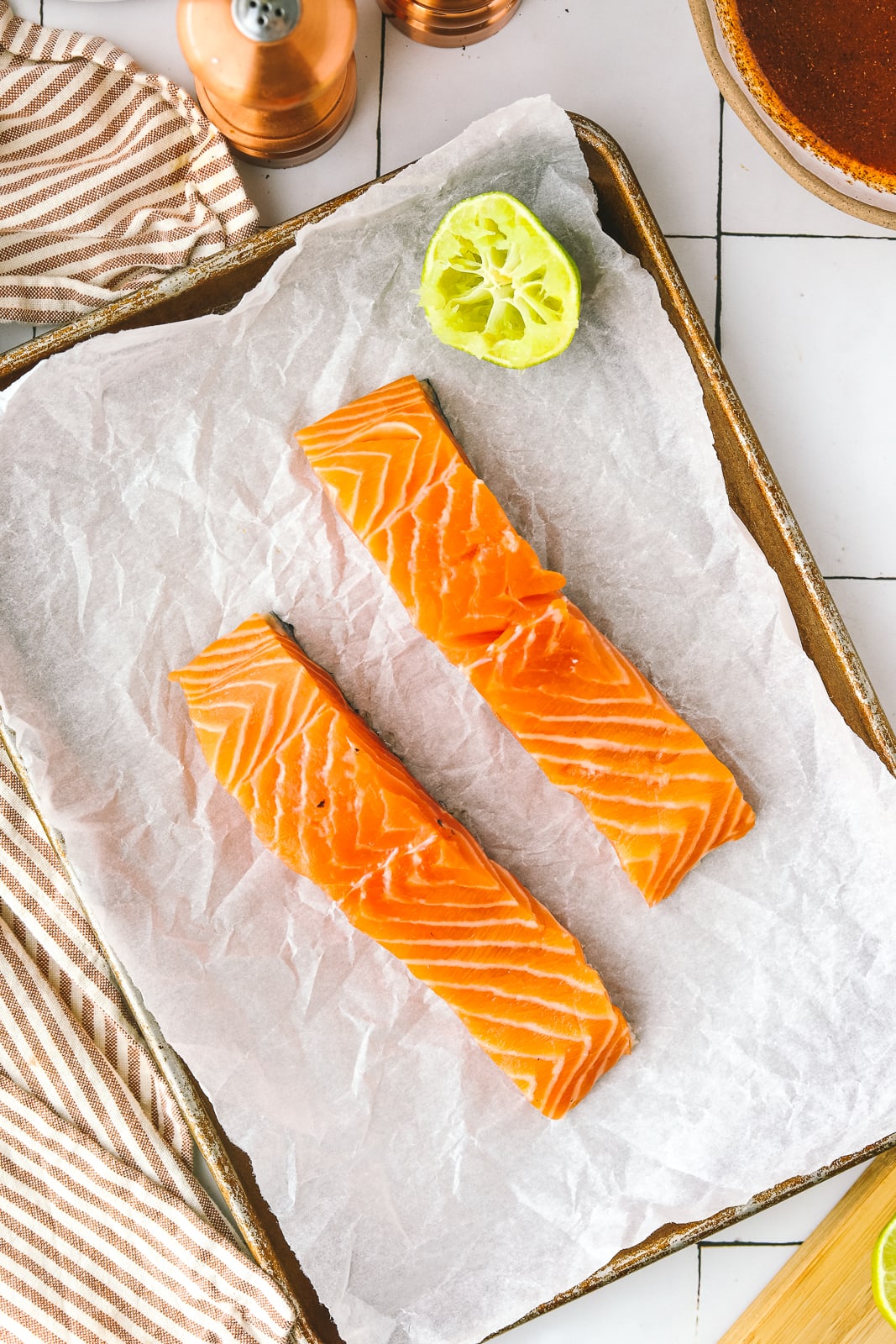 fresh salmon fillets on a sheetpan