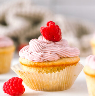 vanilla cupcake topped with raspberry cream cheese frosting