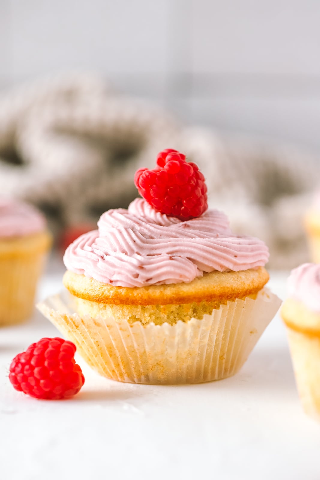 vanilla cupcake topped with raspberry cream cheese frosting