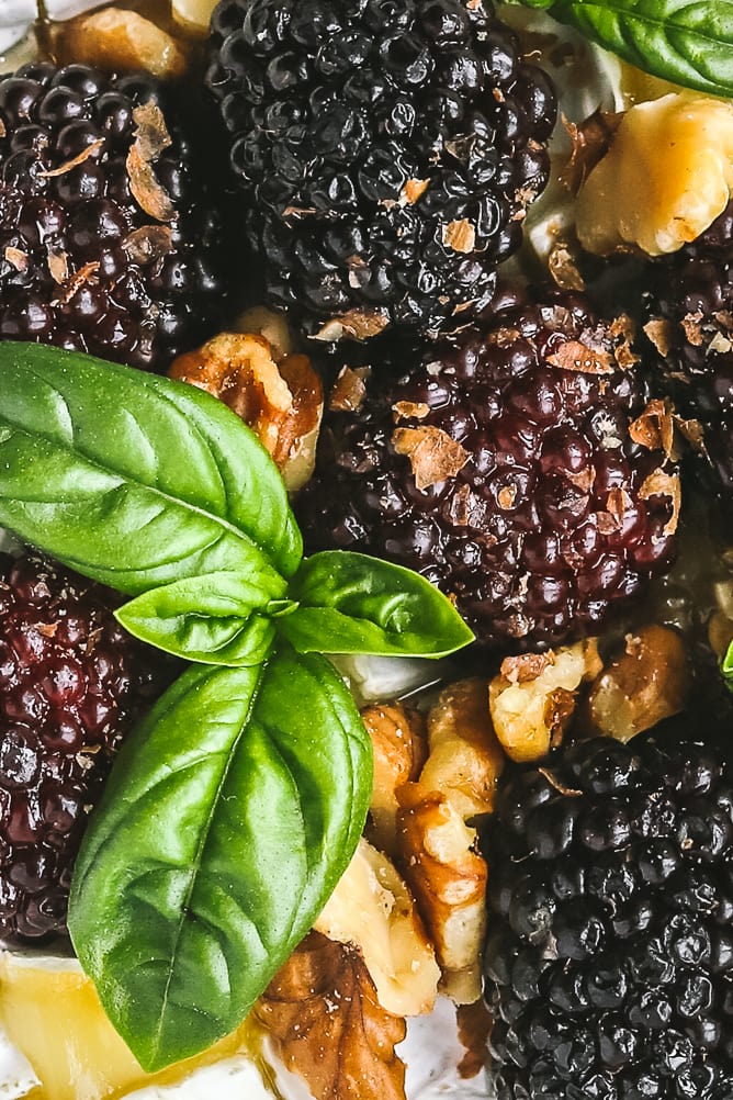 close-up of blackberries, baked brie and walnuts