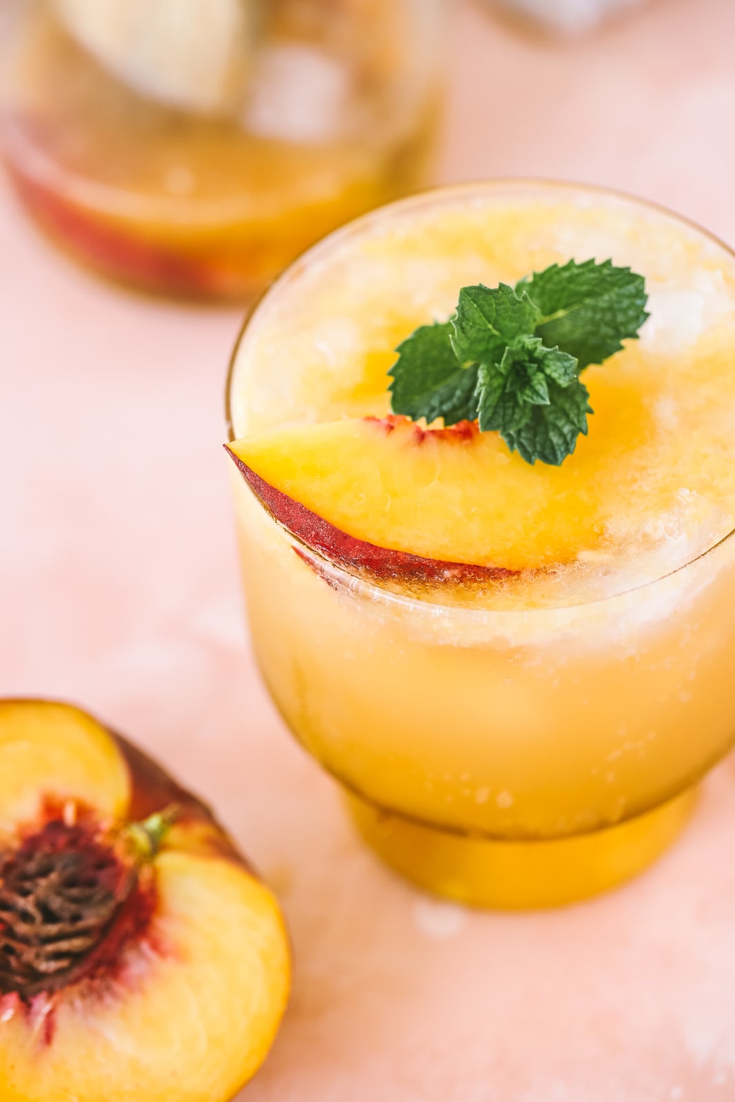 angled shot of peach whiskey cocktail in a cocktail glass