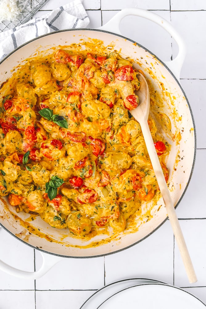 serving spoon in a pan of baked gnocchi