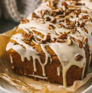 maple icing drizzle with pecans on pumpkin loaf