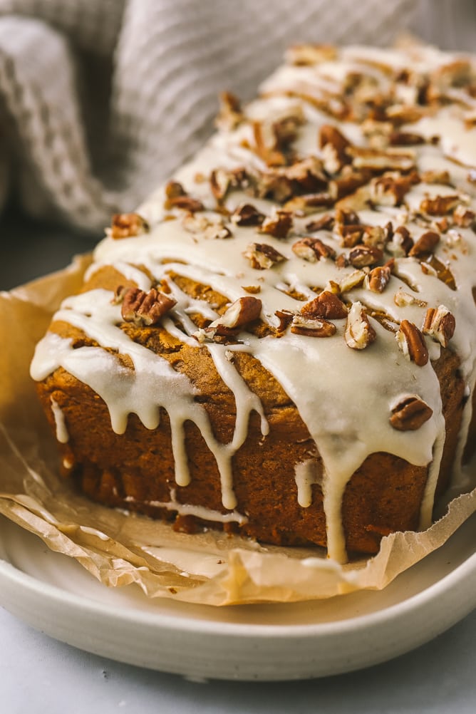 maple icing drizzle with pecans on pumpkin loaf