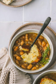 top view of french onion soup with cheesy toast and spoon