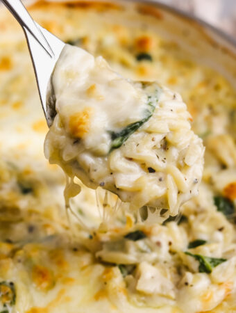 side angle spoonful of spinach artichoke orzo
