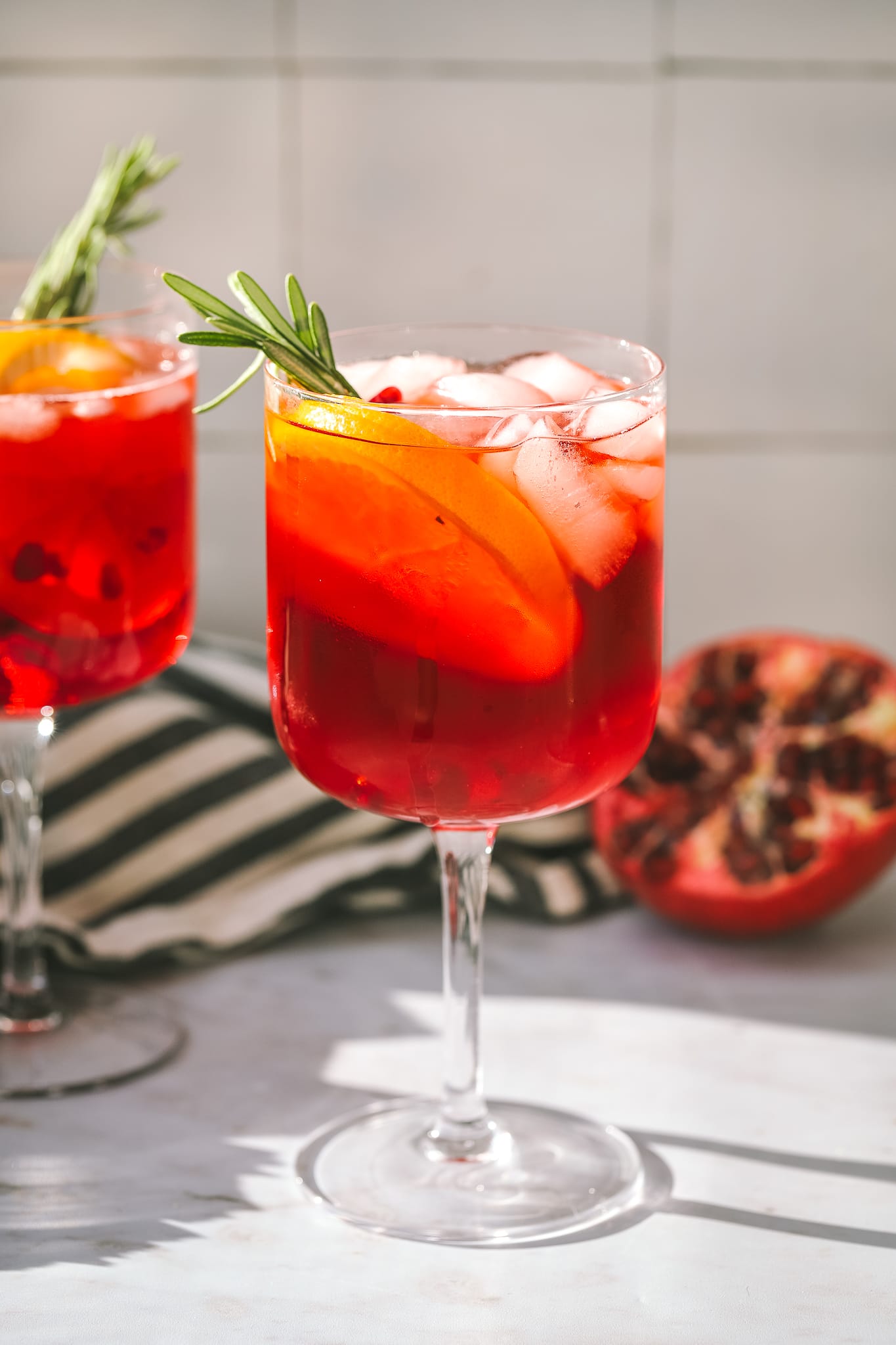 pomegranate aperol spritz in a wine glass