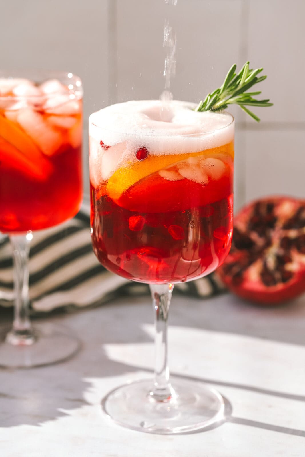 prosecco being poured into a holiday cocktail