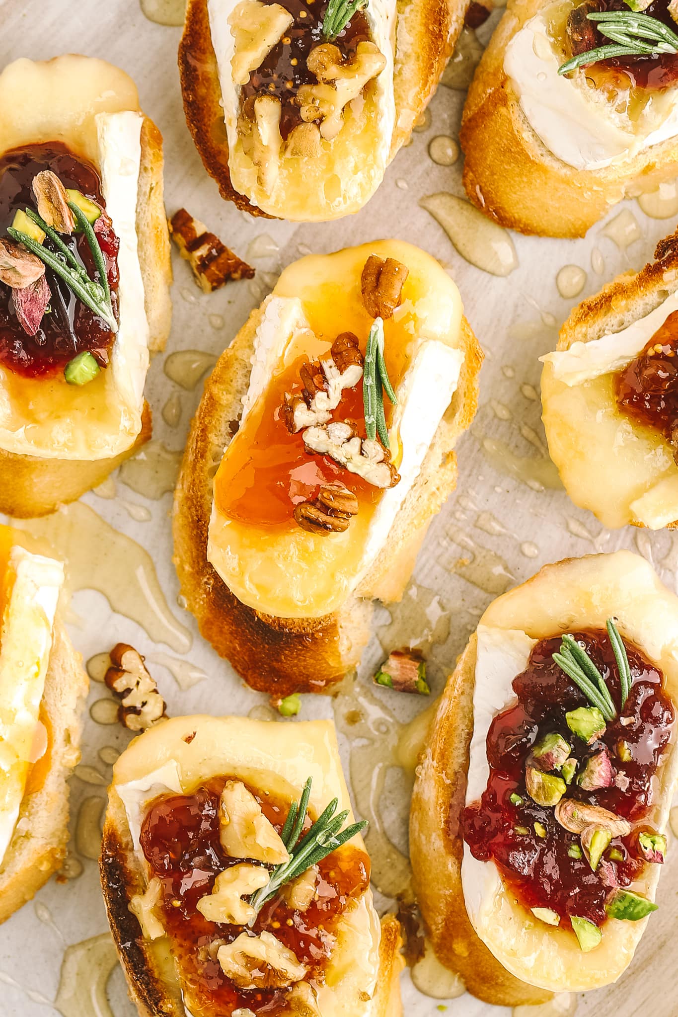 closeup of baguette with brie cheese, apricot jam and pecans