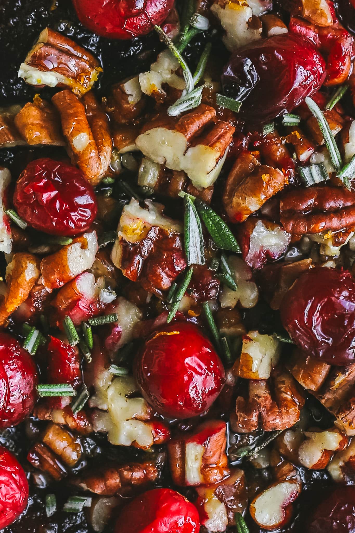 closeup of ingredients for baked brie - cranberries, pecans, rosemary