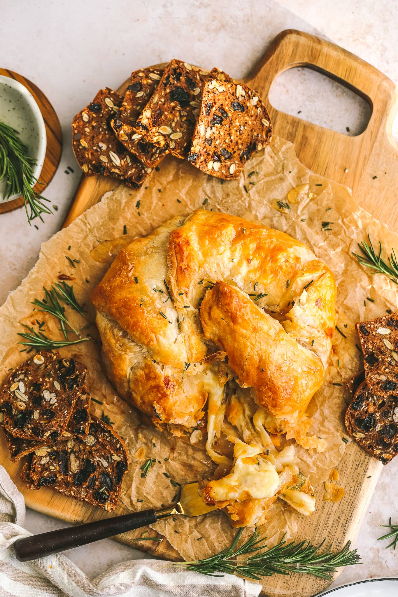baked gruyere on a serving tray with crackers