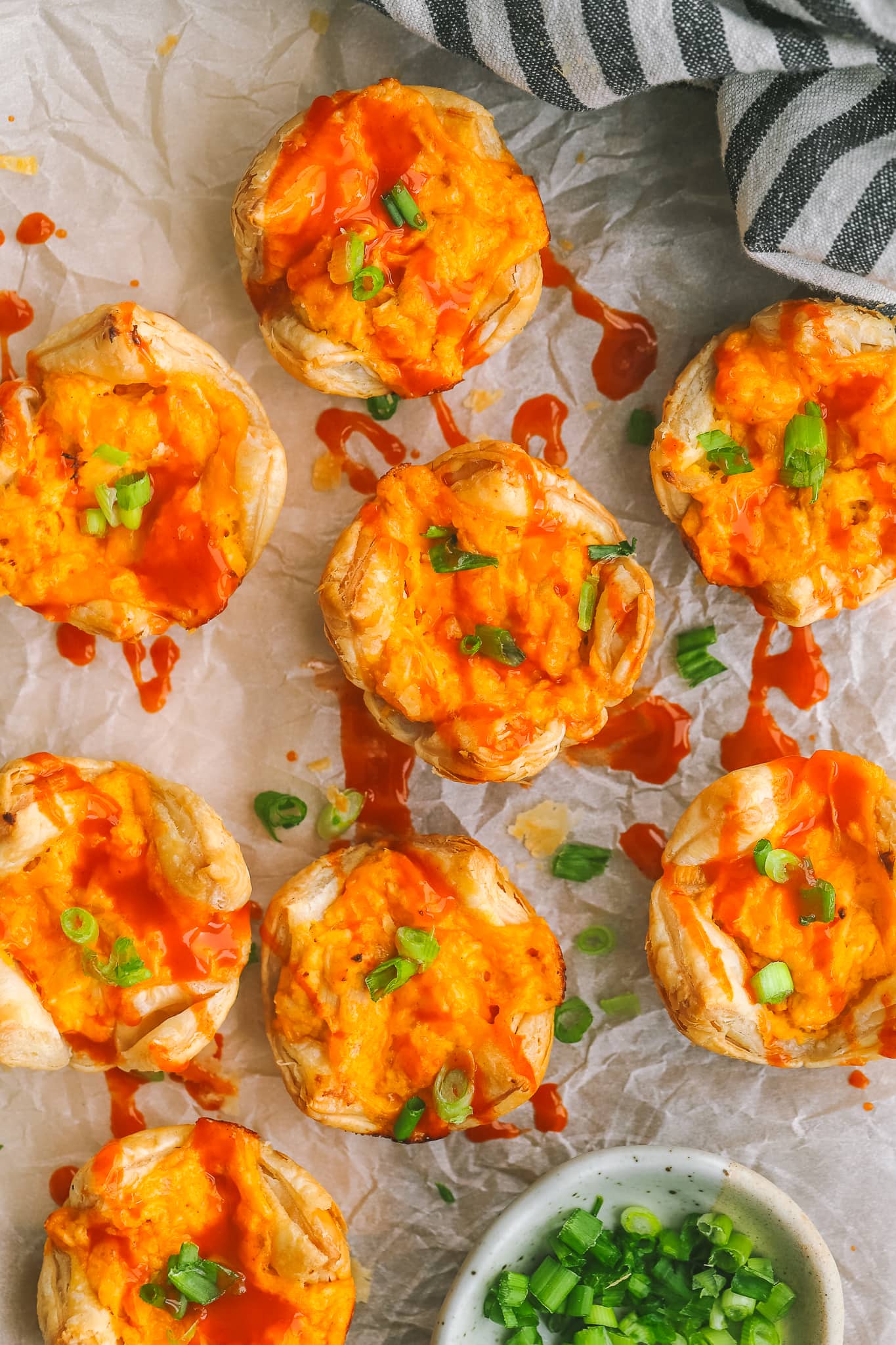 buffalo chicken bites on a serving tray drizzled with buffalo sauce