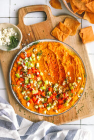 The Best Quick and Easy Spicy Buffalo Hummus Dip spicy buffalo hummus on a plate with garnishes
