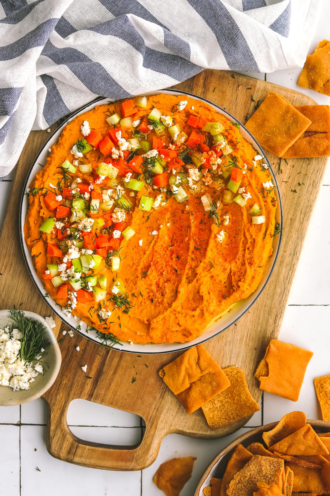 spicy buffalo hummus on a plate with garnishes
