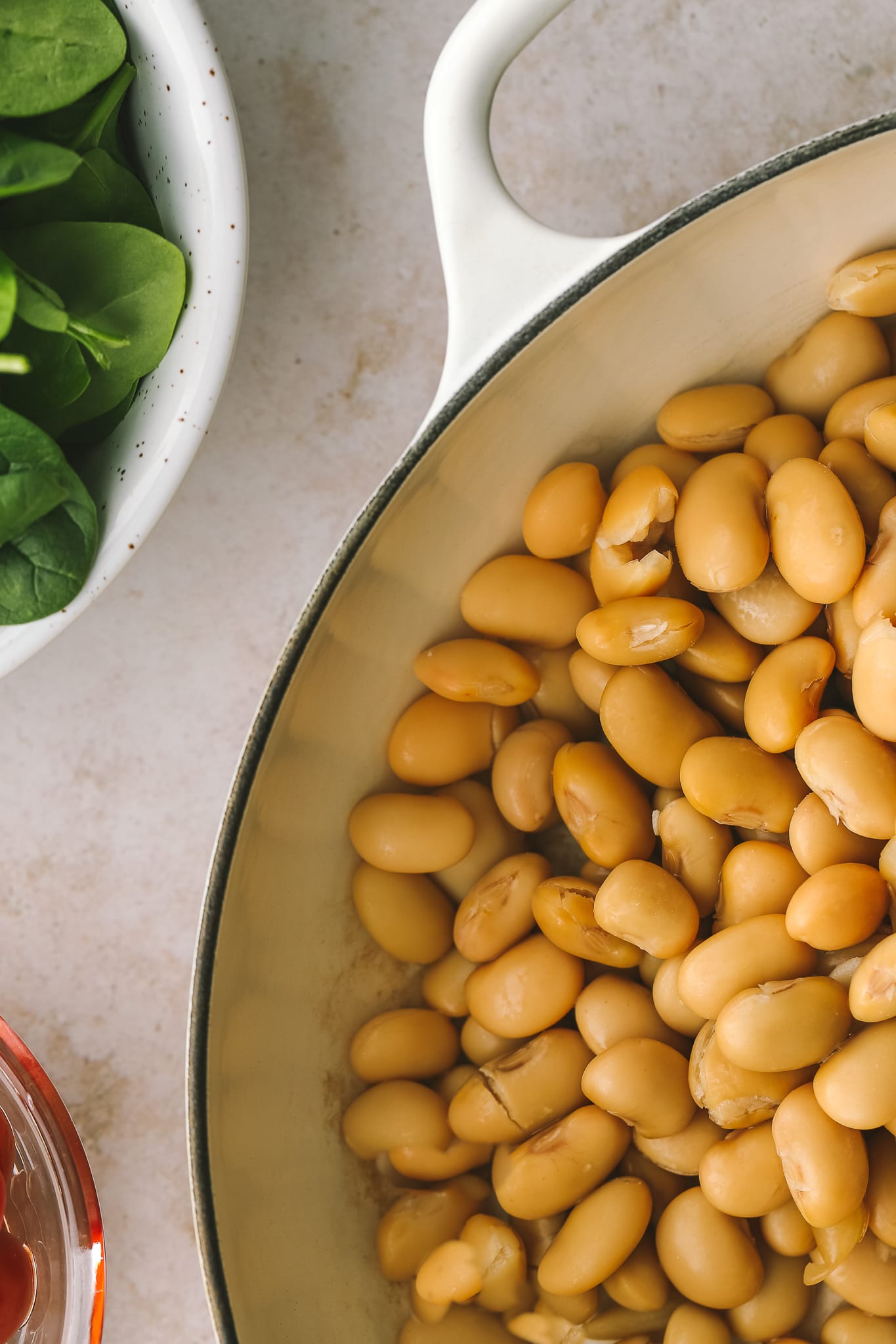 drained butter beans in a pan