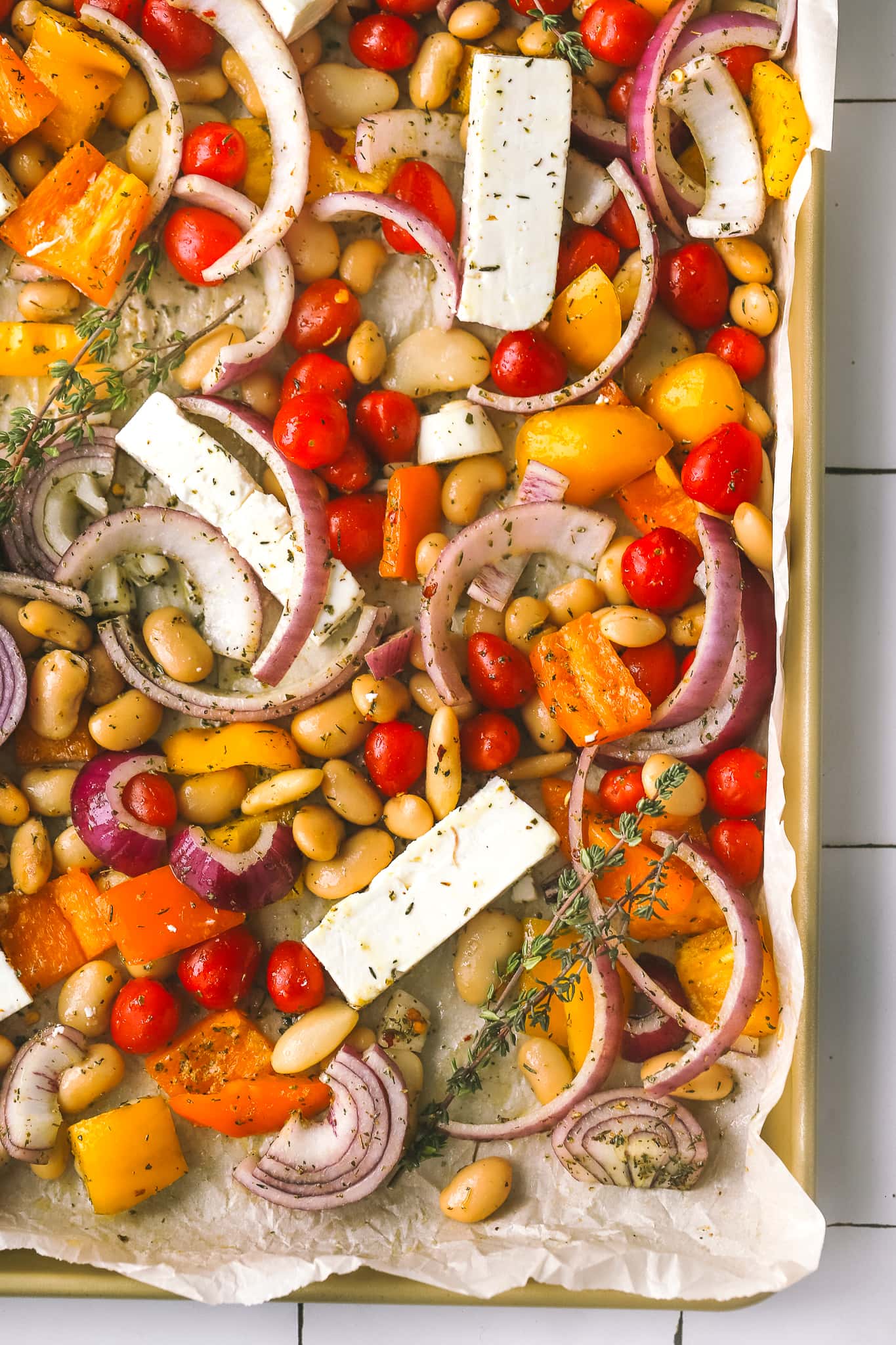 vegetables and beans mixed on a sheet pan