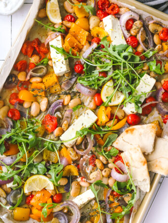 overhead photo of sheet pan dinner with feta and vegetables