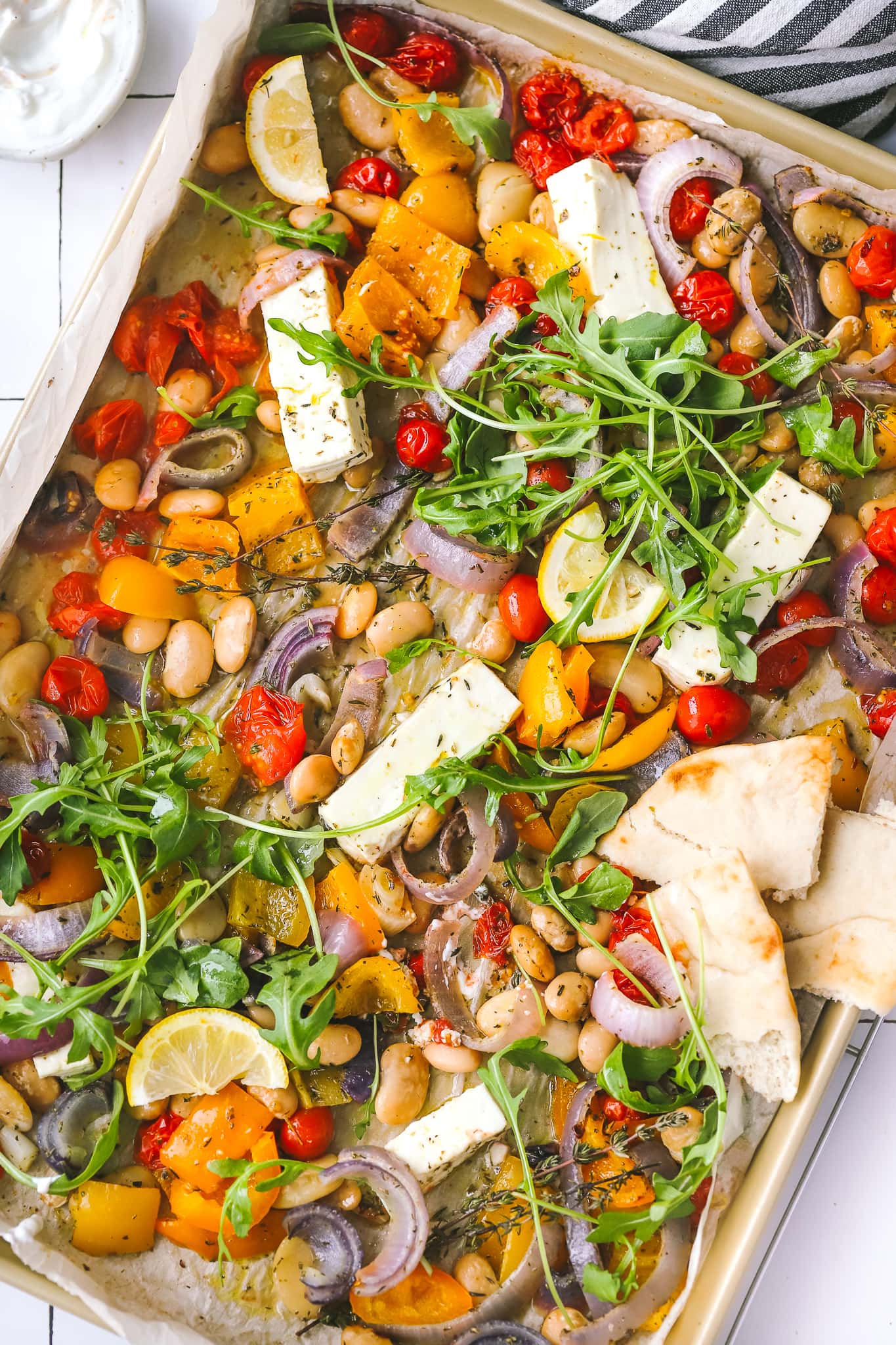 overhead photo of sheet pan dinner with feta and vegetables