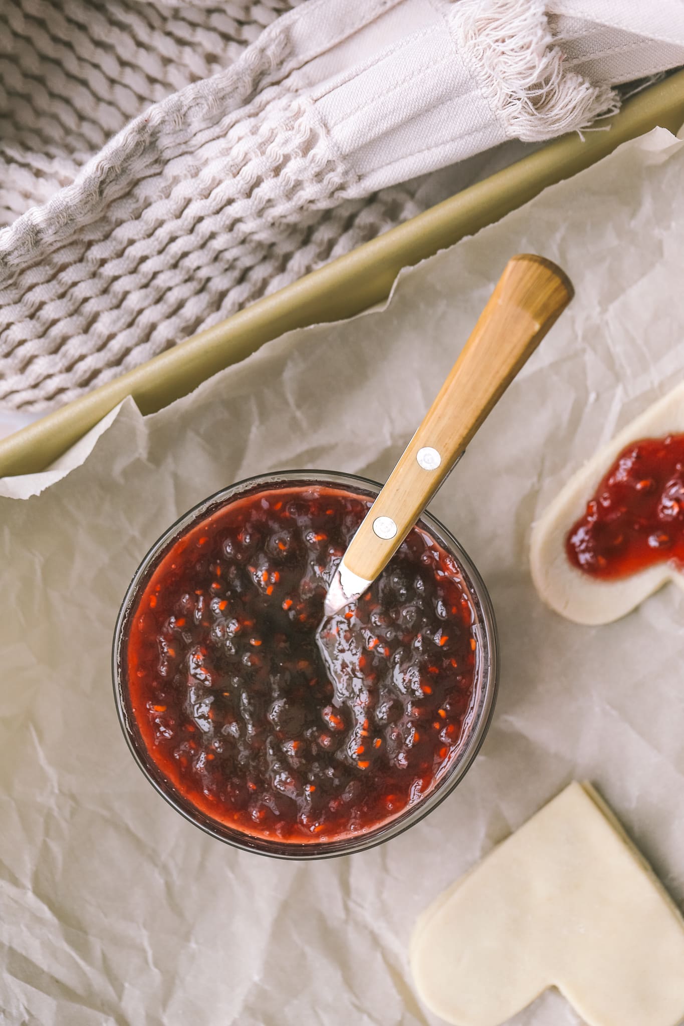 raspberry jam in a bowl with a spoon