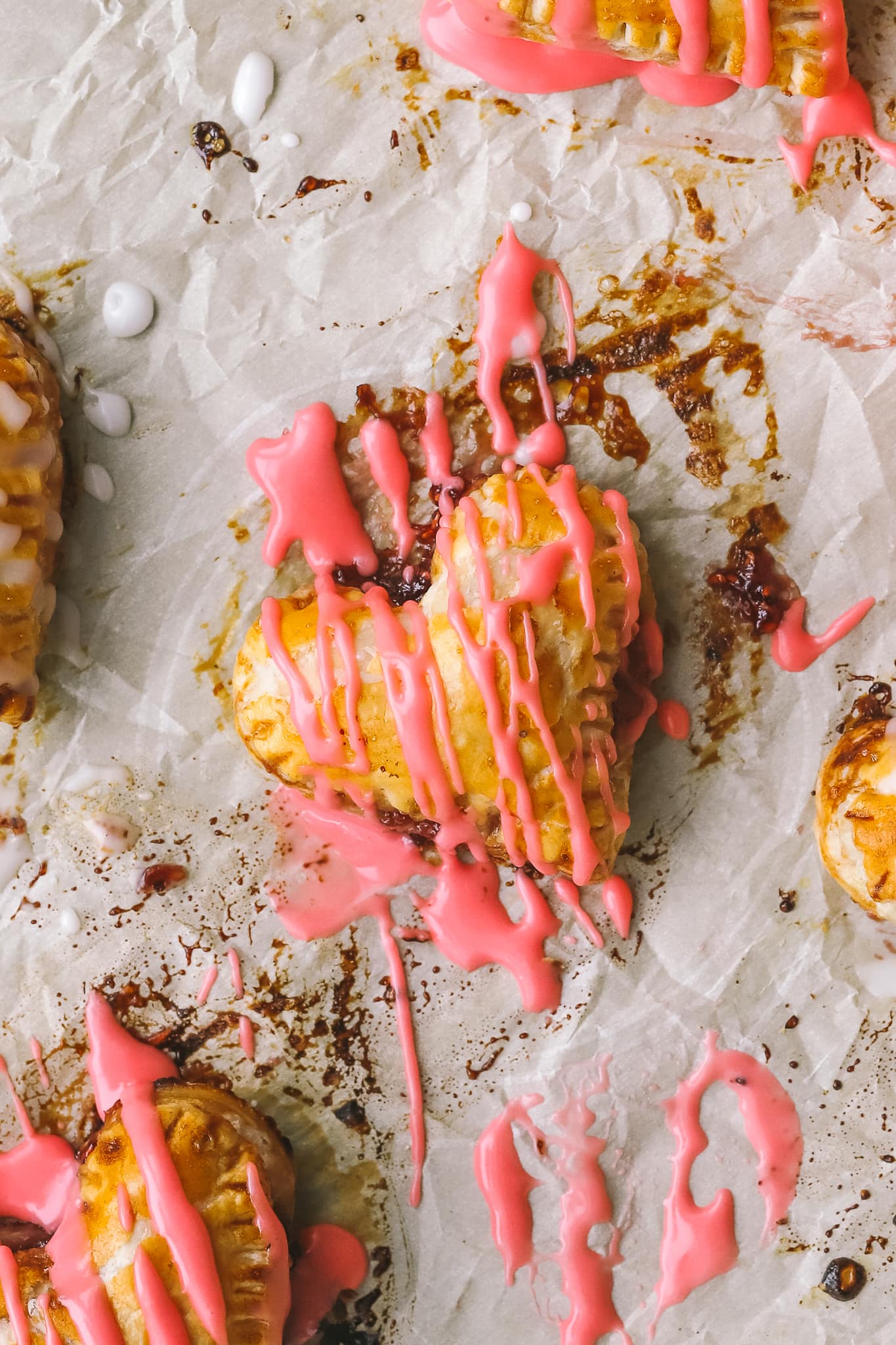 closeup of pink icing on a mini heart shaped pie