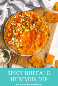 spicy buffalo hummus on a plate with garnishes