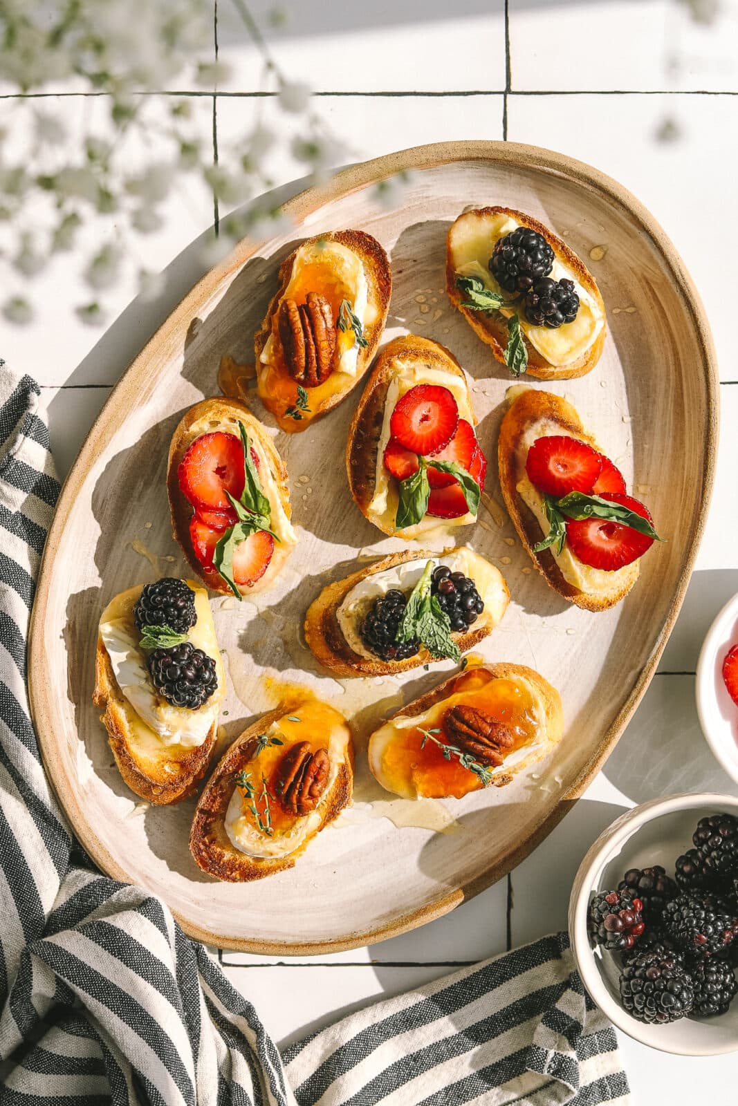 berries and brie on crostini on a platter