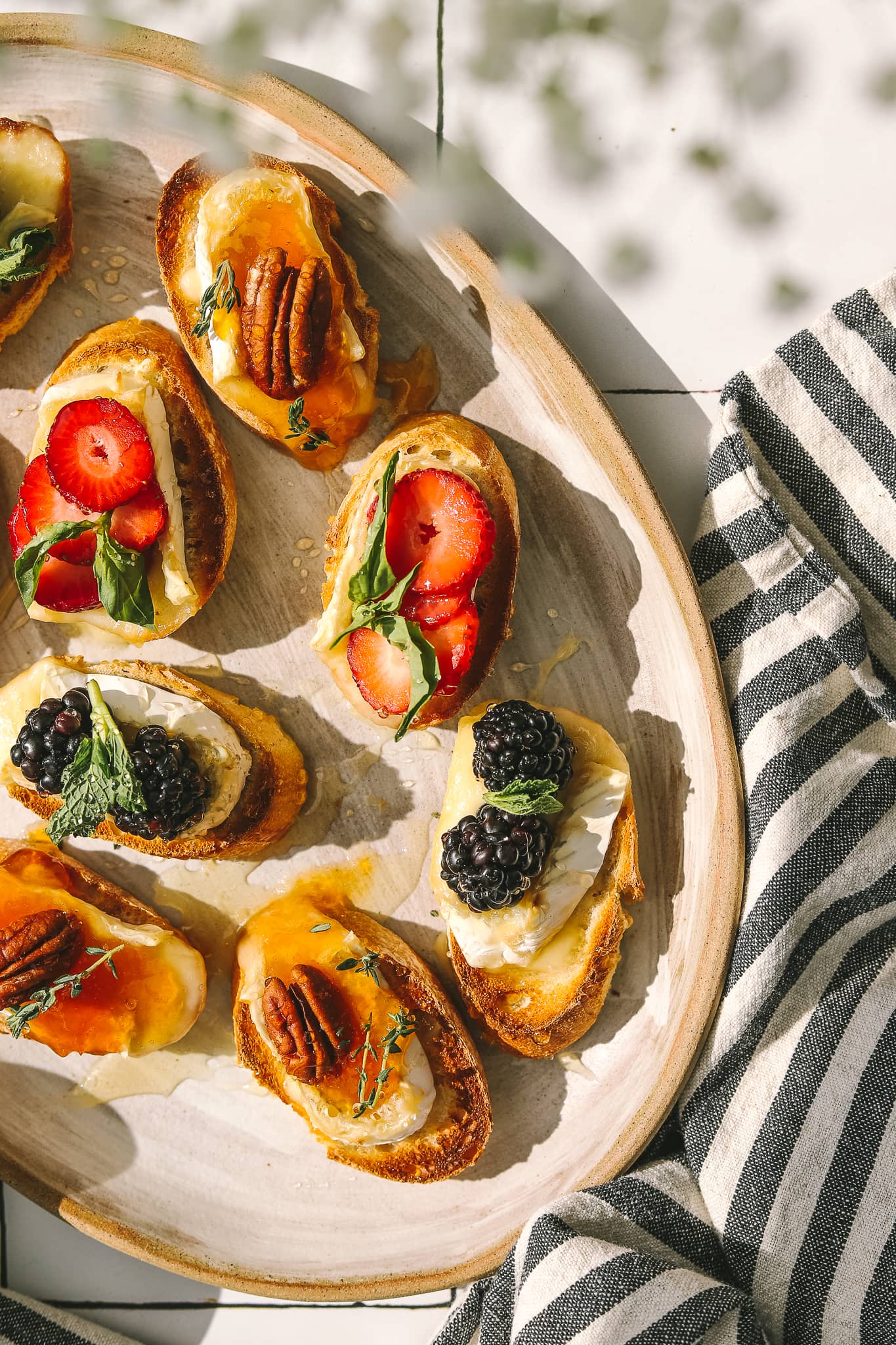berries and brie on crostini on a platter